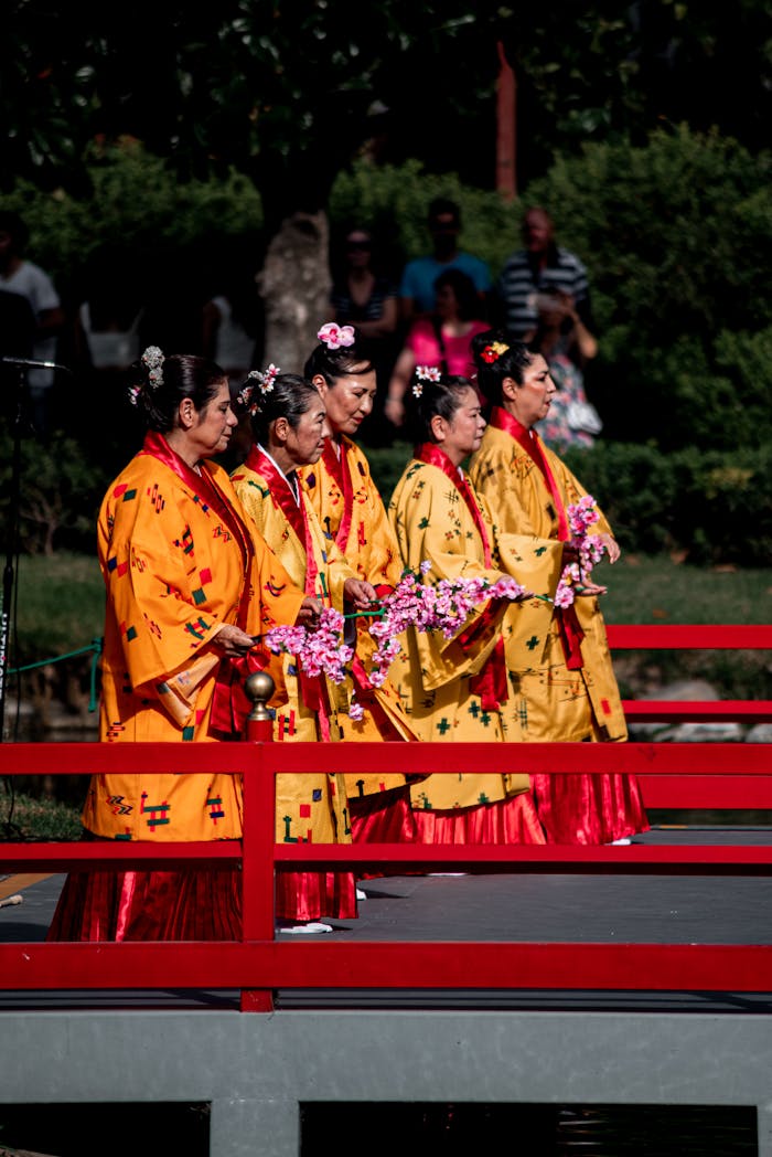services-03 Five women perform traditional Japanese dance in a garden in Buenos Aires.