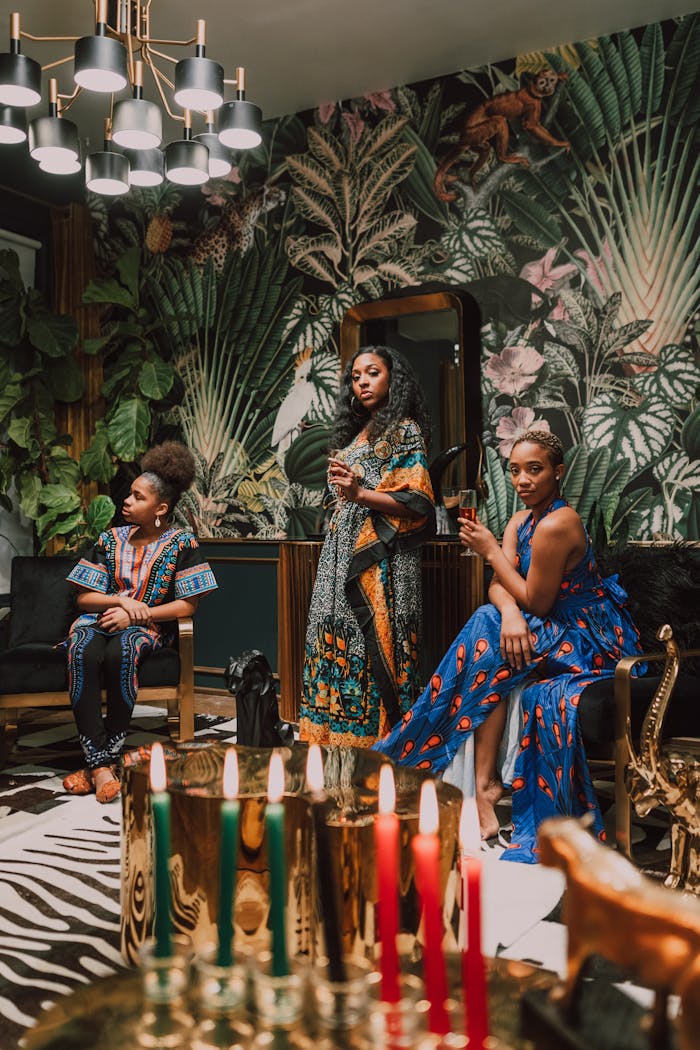 A vibrant Kwanzaa celebration featuring women in traditional African attire in a beautifully decorated setting.